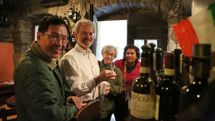 Enjoying wine at a wine bar in a small town on the lakes Al Boeuc